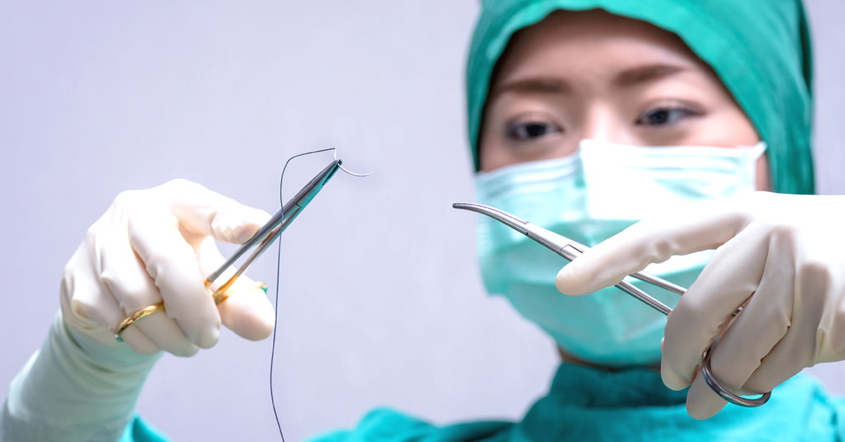 6298-woman_physician_holding_a_suture_needle_in-1200x628-Facebook